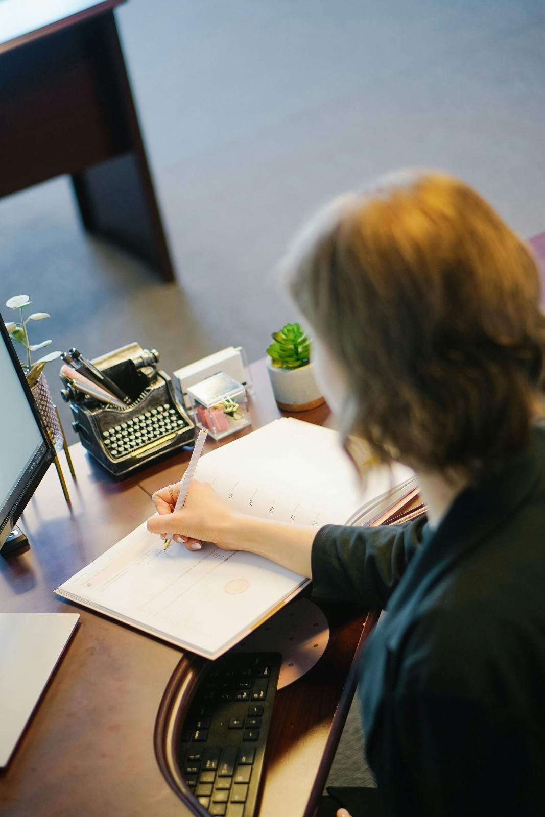 Person writing in a planner